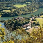an aerial view of a village and a river