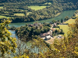 an aerial view of a village and a river