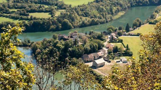 an aerial view of a village and a river